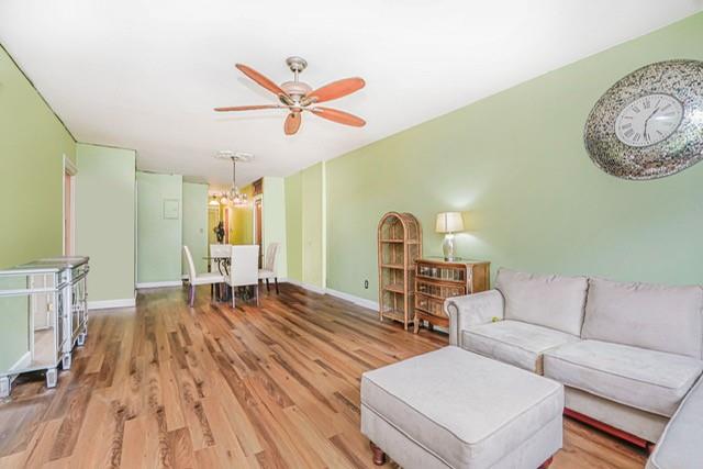 8701 Shore Road, Unit 421 Brooklyn, NY 11209 - Photo 6 of 20 a living room with furniture and a wooden floor