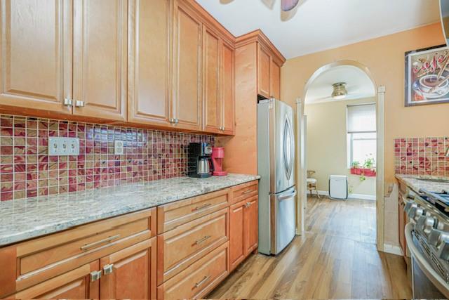 8701 Shore Road, Unit 421 Brooklyn, NY 11209 - Photo 8 of 20 a kitchen with stainless steel appliances granite countertop a sink dishwasher a refrigerator and cabinets with wooden floor