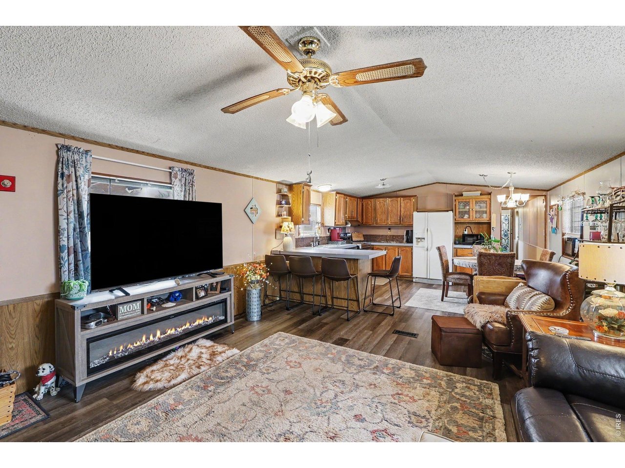 1401 9th Street, Unit 159 Fort Lupton, CO 80621 - Photo 20 of 24 Cozy living room showing the open floor plan and new vinyl flooring.