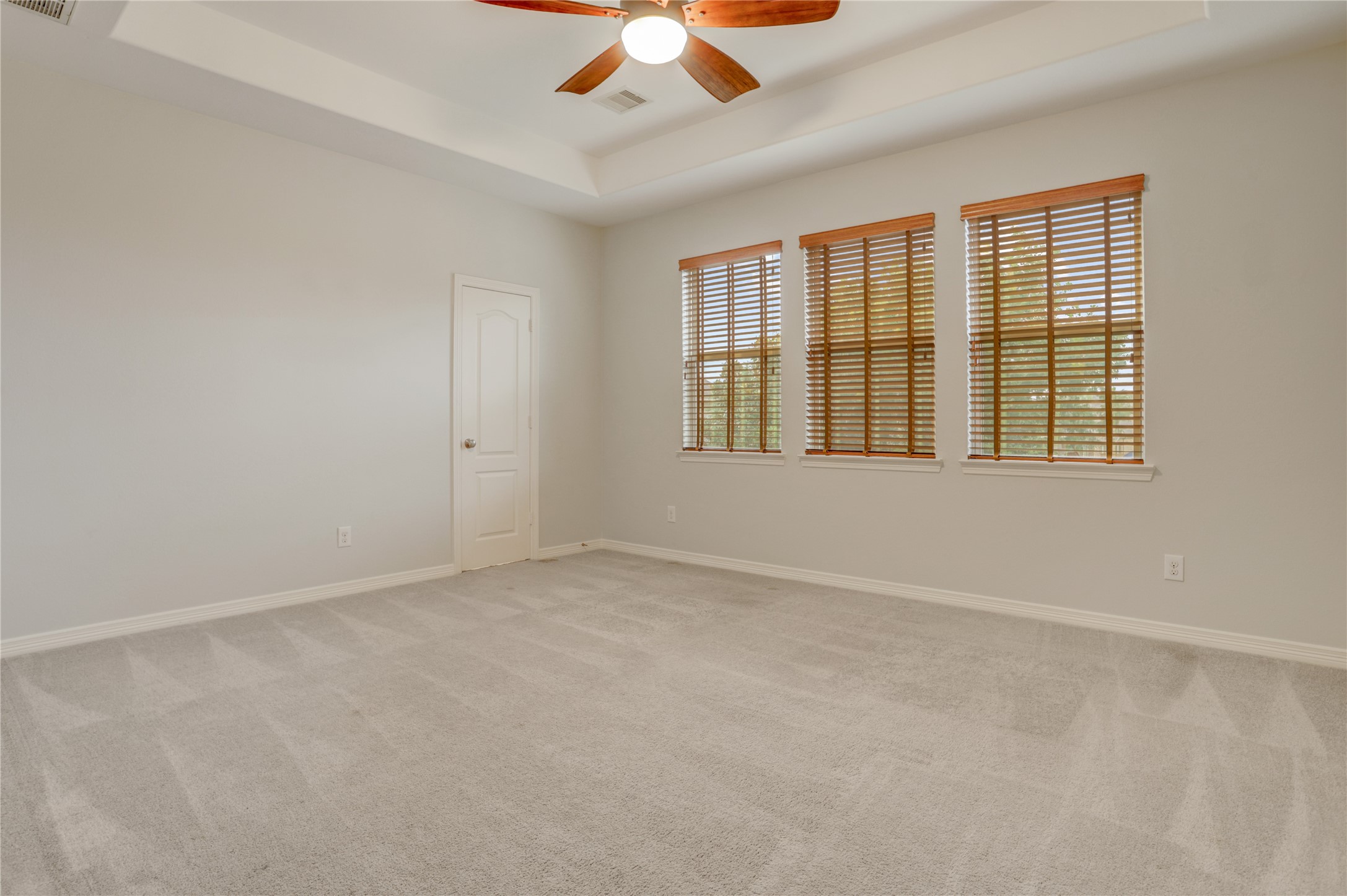 3002 Currant Drive Manvel, TX 77578 - Photo 30 of 43 an empty room with chandelier fan and windows