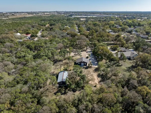 an aerial view of a houses with a yard
