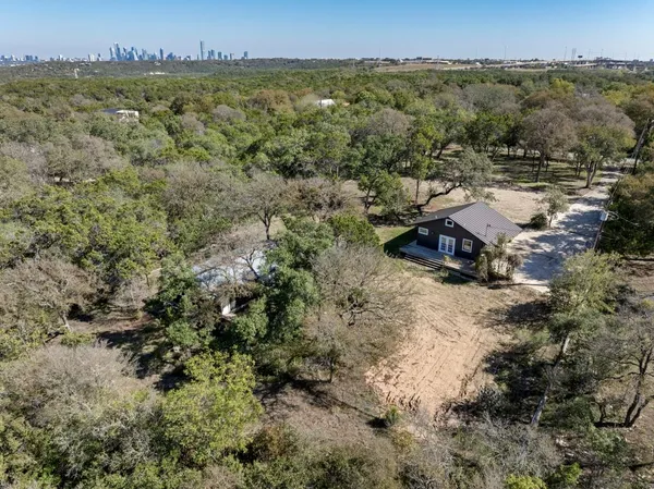 an aerial view of a houses with a yard