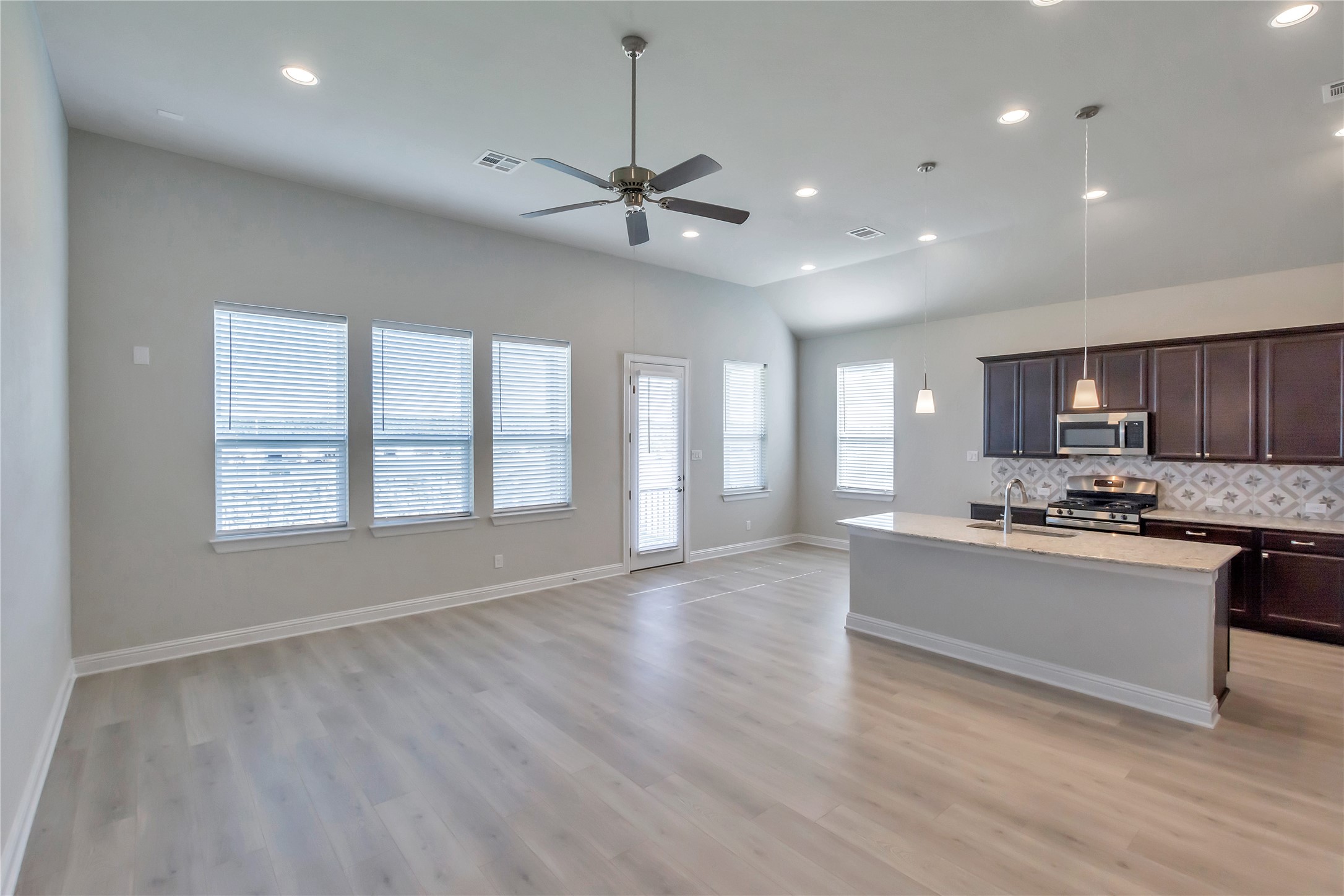 2140 Base Burner Path Leander, TX 78641 - Photo 6 of 27 a large kitchen with stainless steel appliances granite countertop a stove and a white cabinets