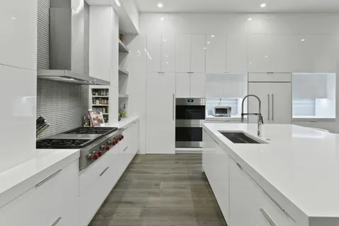 a kitchen with stainless steel appliances granite countertop a sink stove and cabinets