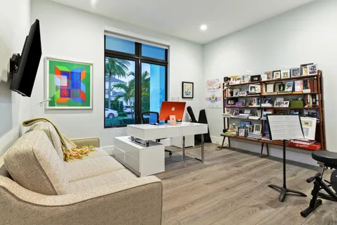 a living room with furniture and a floor to ceiling window