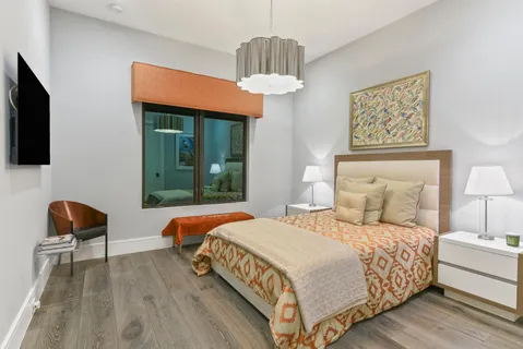 a bedroom with a bed and a chair