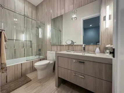 a bathroom with a double vanity sink toilet and shower