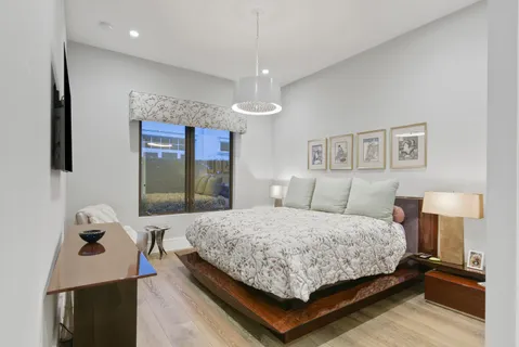 a bedroom with a bed and wooden floor