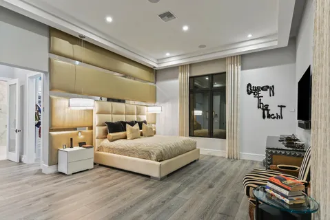 a bedroom with a bed and a mirror