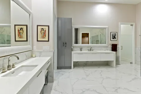 a bathroom with a tub sink and mirror