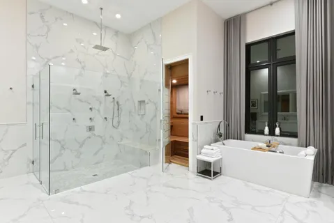 a bathroom with a bathtub shower sink and toilet