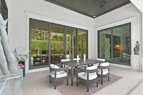 a dining room with furniture wooden floor and a flat screen tv