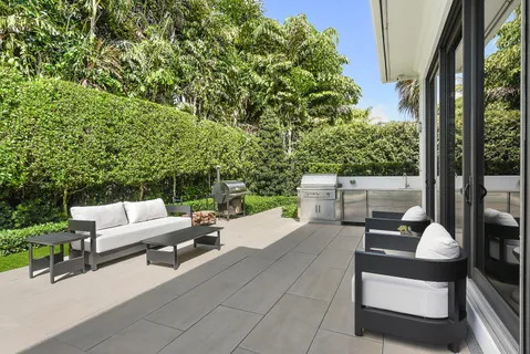 a balcony with furniture and a potted plant