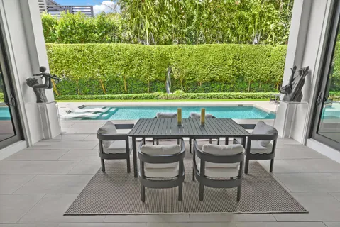 a view of a chairs and table in patio