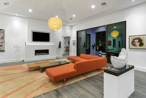 a living room with fireplace furniture and a flat screen tv