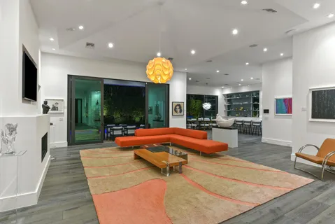 a living room with fireplace furniture and a large window