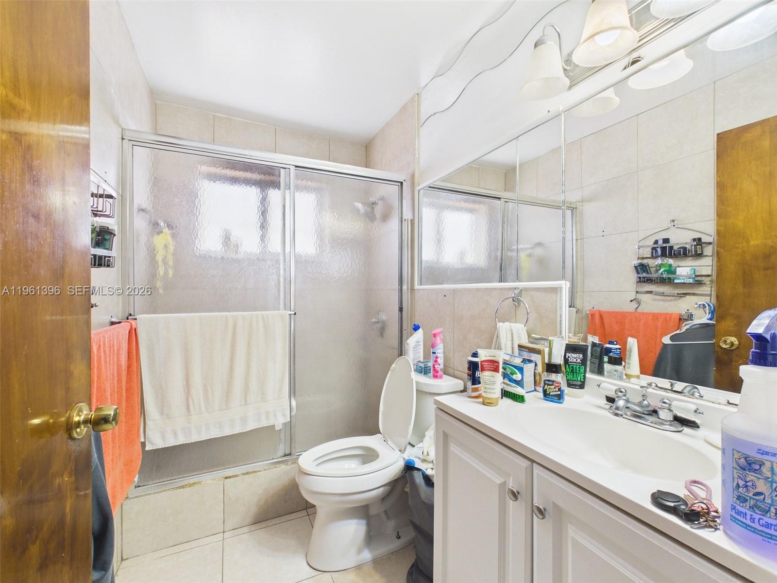 46 Northwest 24th Court Miami, FL 33125 - Photo 12 of 19 a bathroom with a sink vanity mirror and toilet