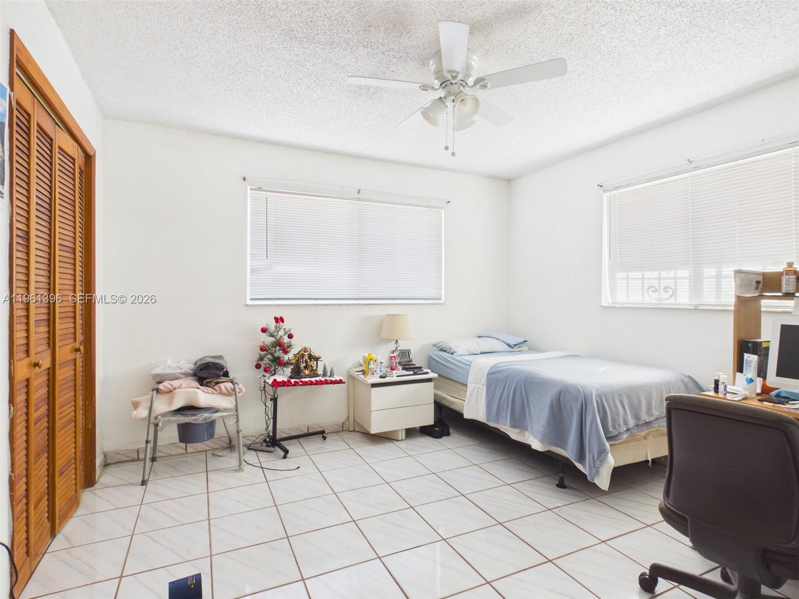 46 Northwest 24th Court Miami, FL 33125 - Photo 13 of 19 a bedroom with bed and window