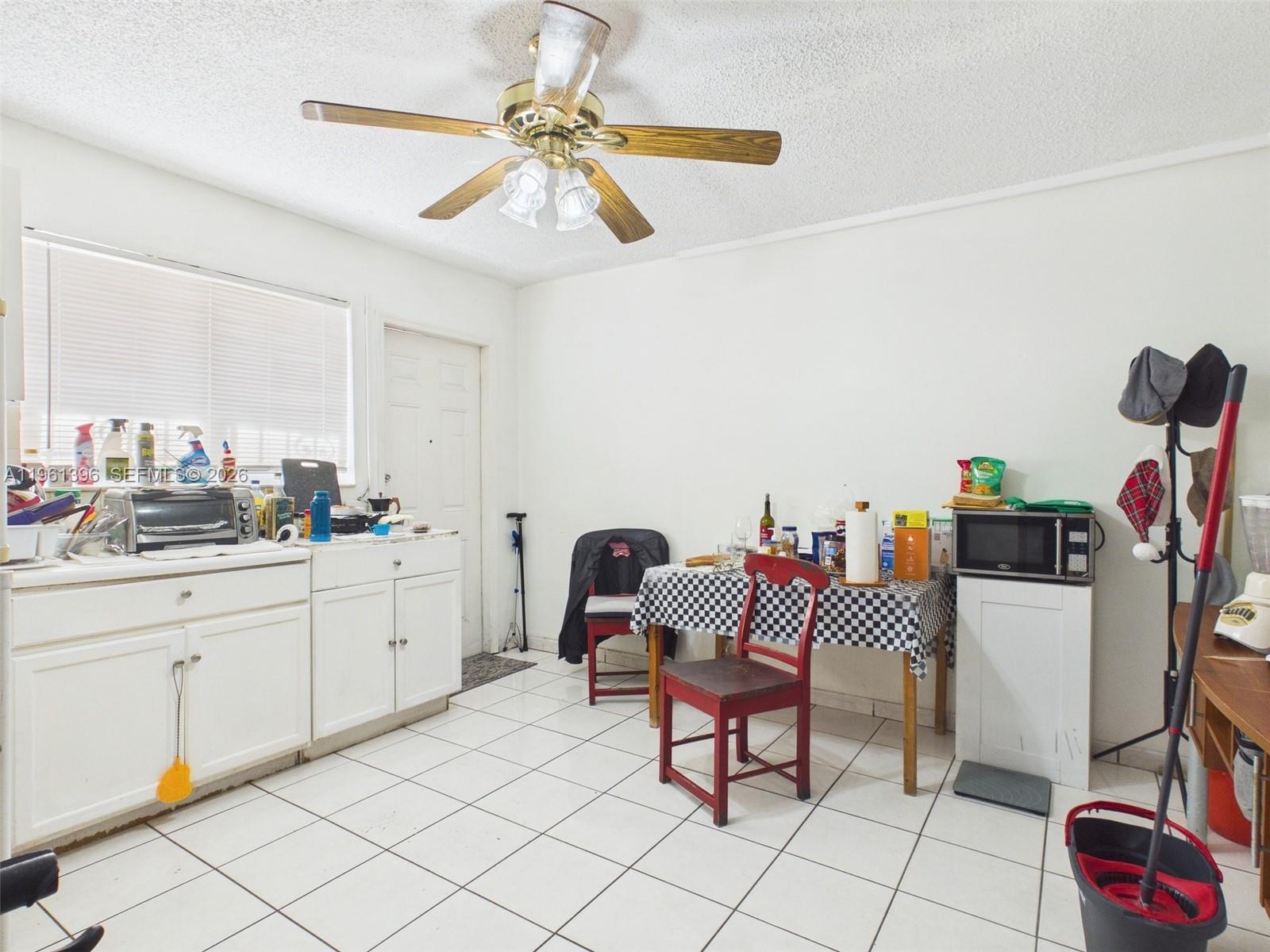 46 Northwest 24th Court Miami, FL 33125 - Photo 15 of 19 a kitchen with a dining table and chairs