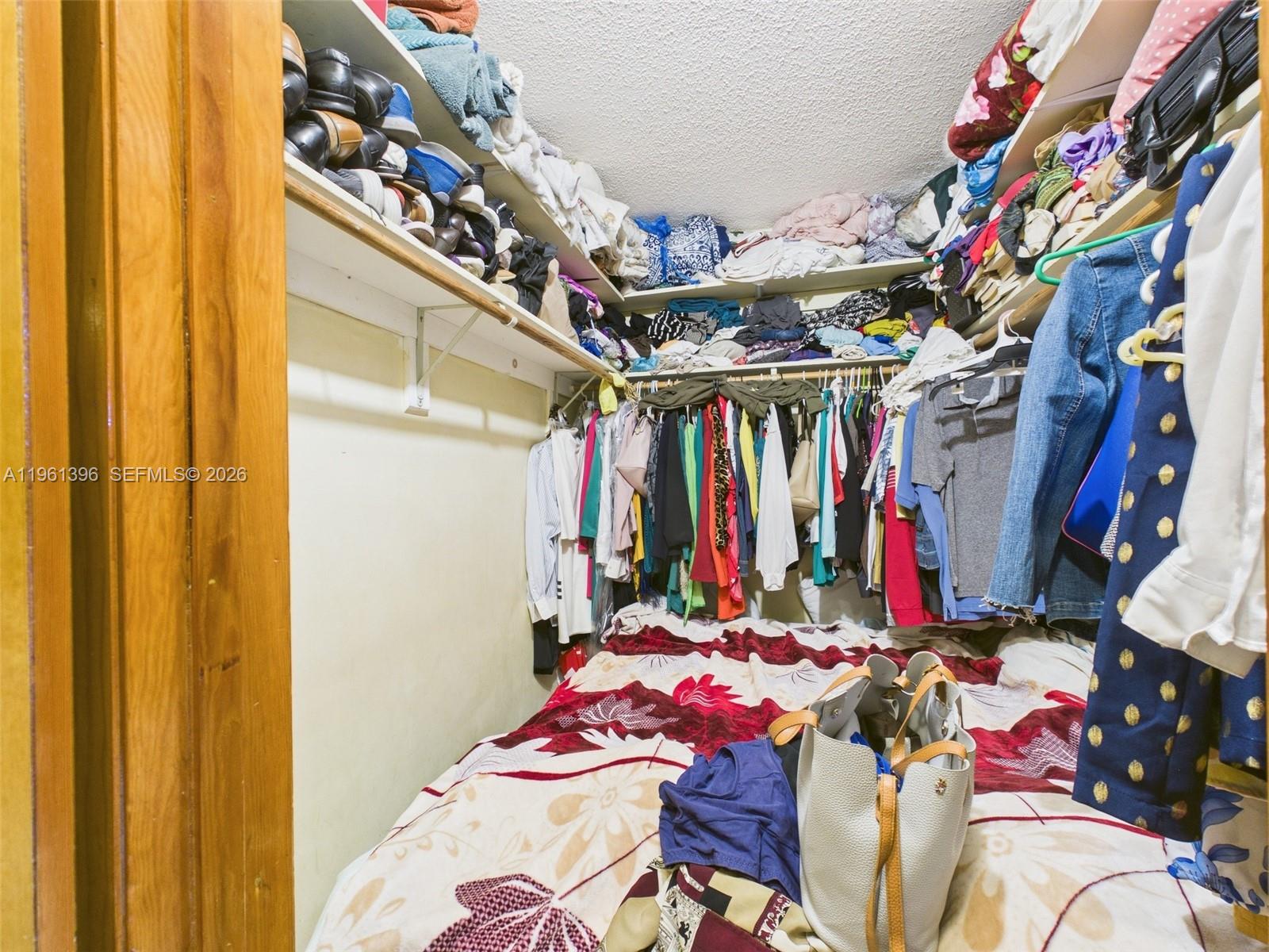 46 Northwest 24th Court Miami, FL 33125 - Photo 16 of 19 a view of walk in closet with clothes