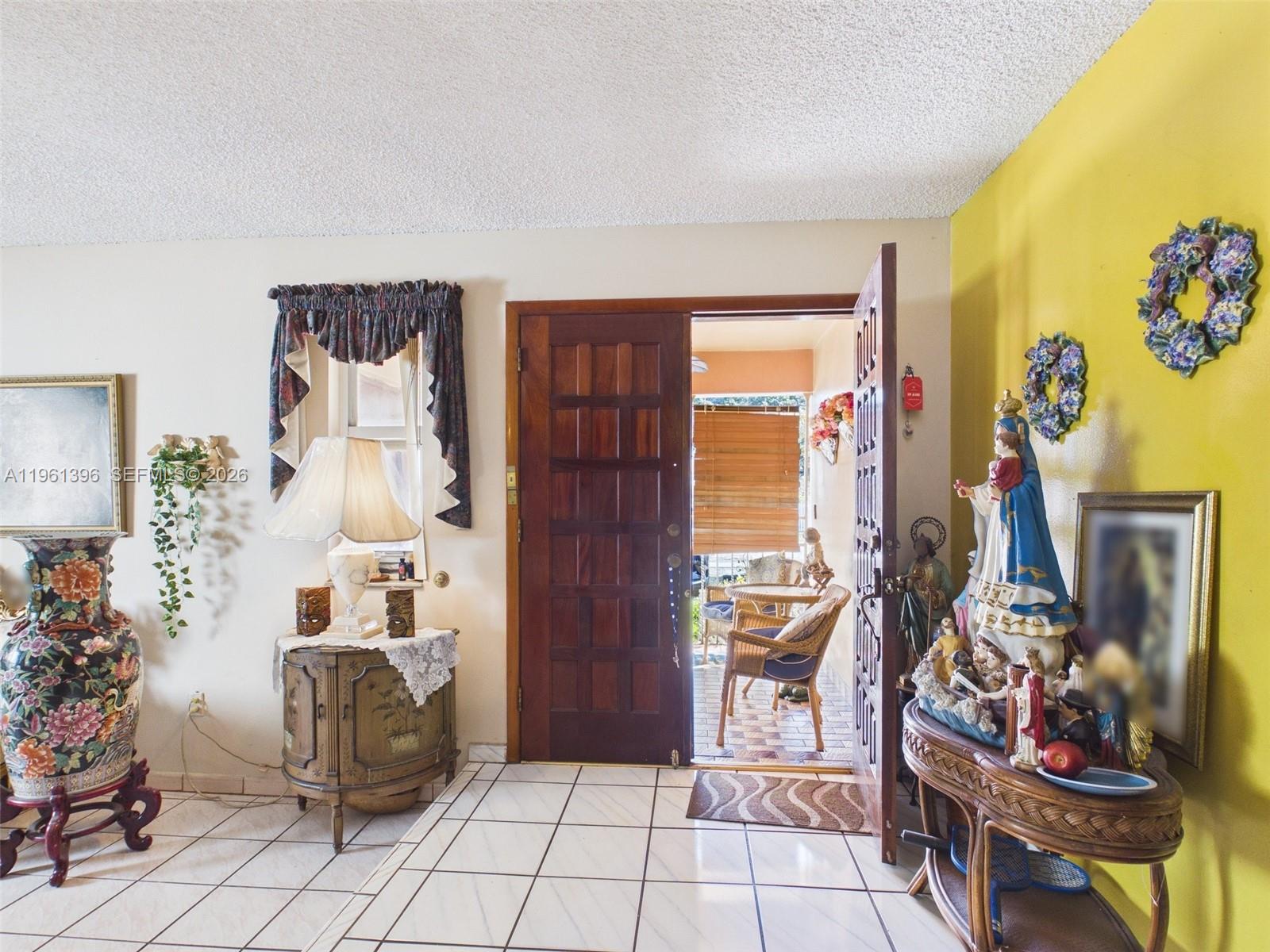 46 Northwest 24th Court Miami, FL 33125 - Photo 5 of 19 a room with lots of different colored cloths