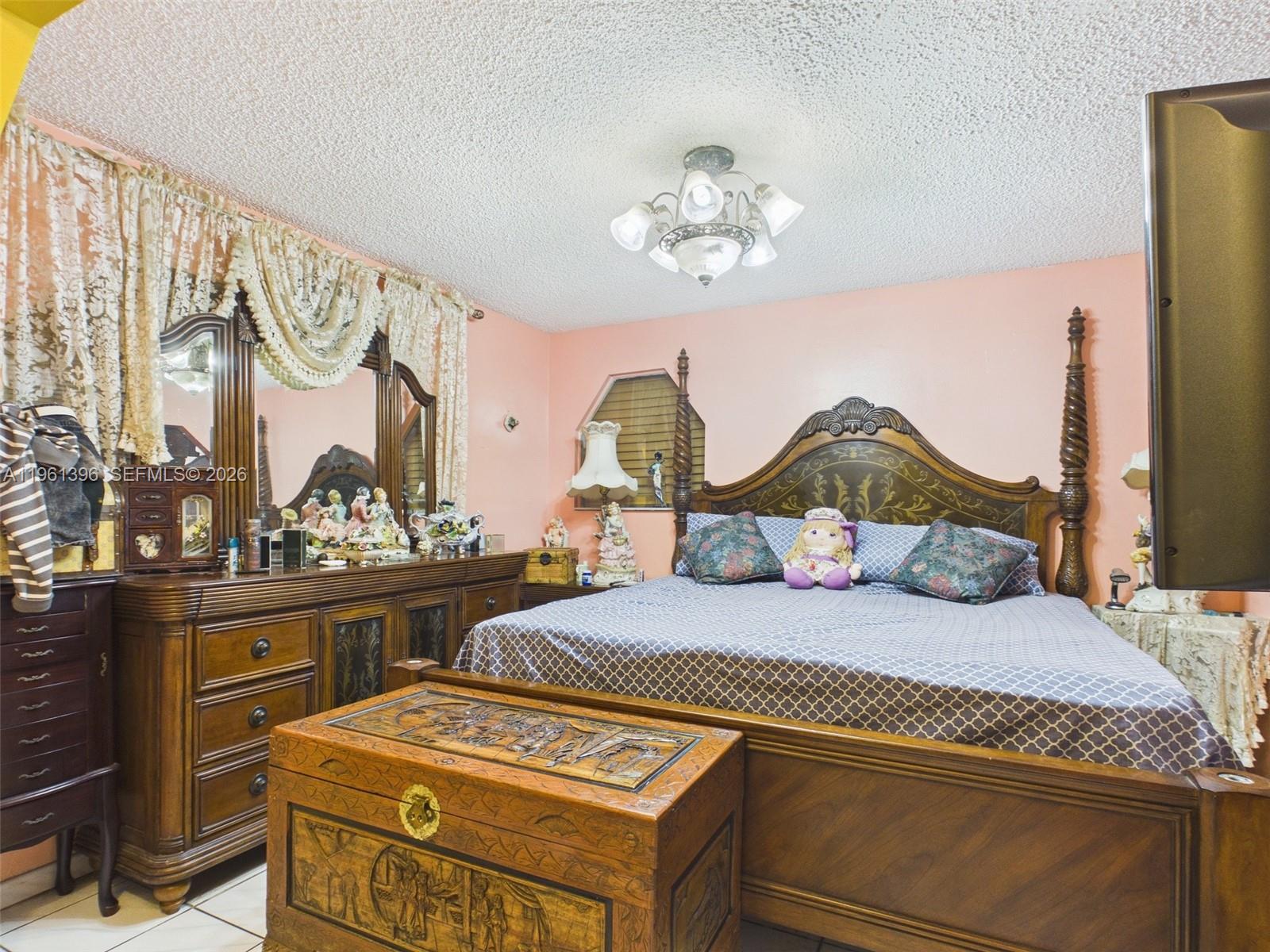 46 Northwest 24th Court Miami, FL 33125 - Photo 8 of 19 a bedroom with a bed and a chandelier