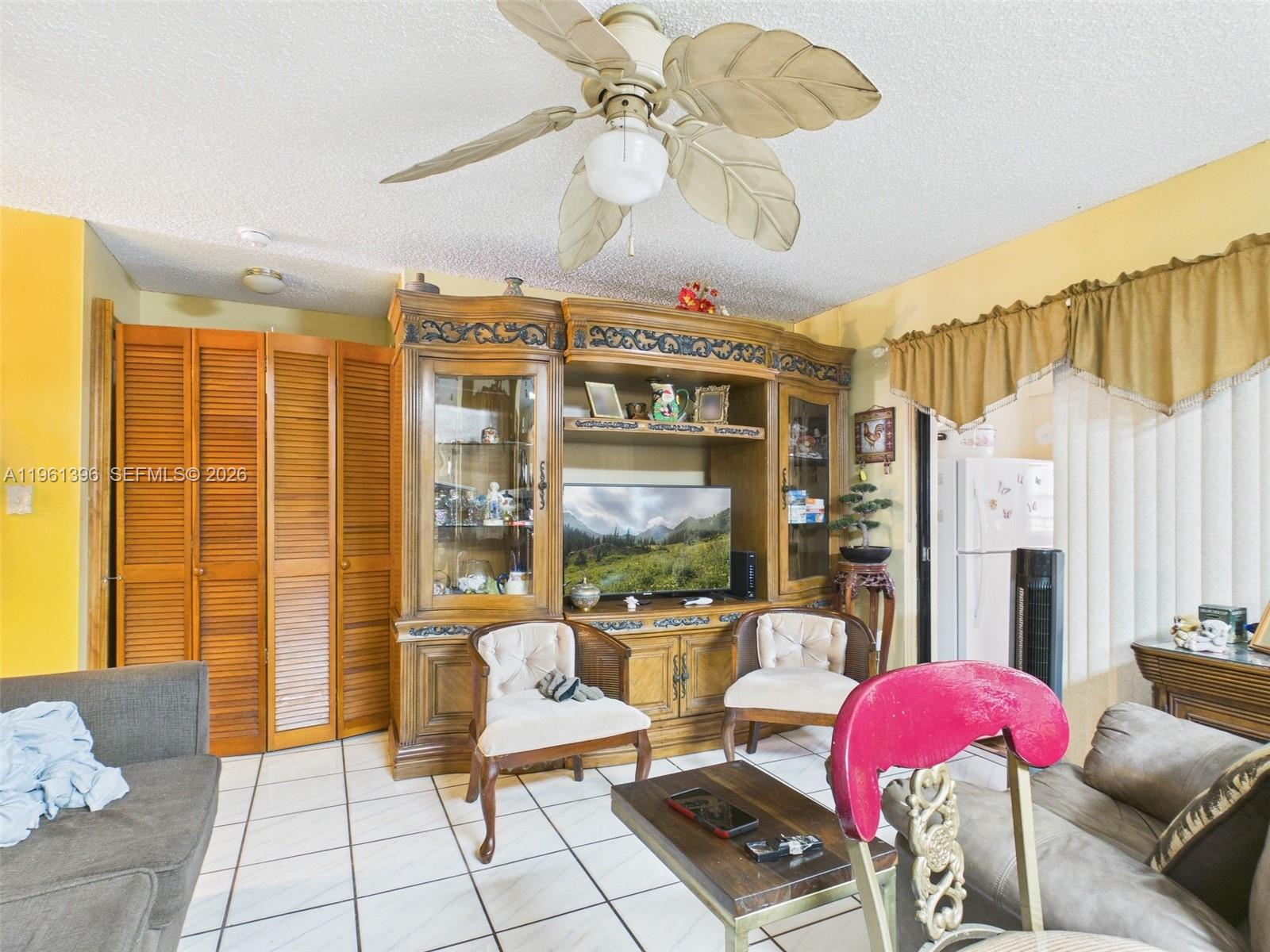 46 Northwest 24th Court Miami, FL 33125 - Photo 9 of 19 a living room with furniture and a large window