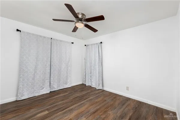 a view of a ceiling fan and wooden floor