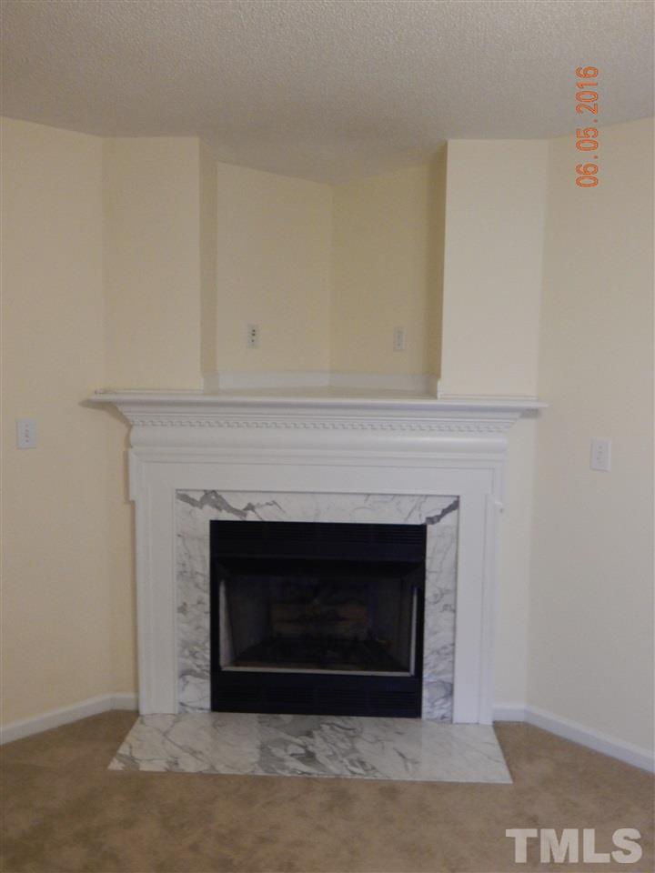 4708 Windbreak Lane Raleigh, NC 27616 - Photo 4 of 13 a living room with a fireplace