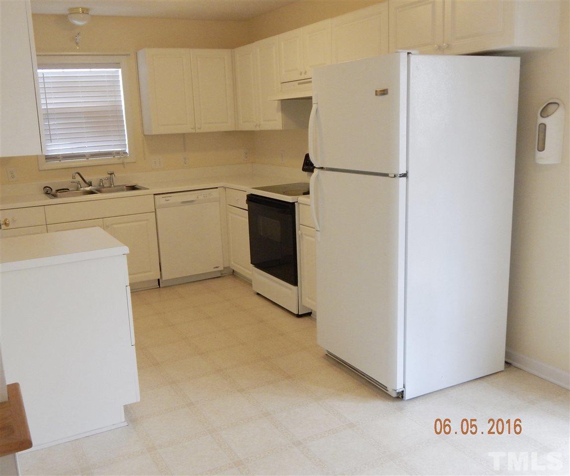 4708 Windbreak Lane Raleigh, NC 27616 - Photo 5 of 13 a white refrigerator freezer sitting in a kitchen
