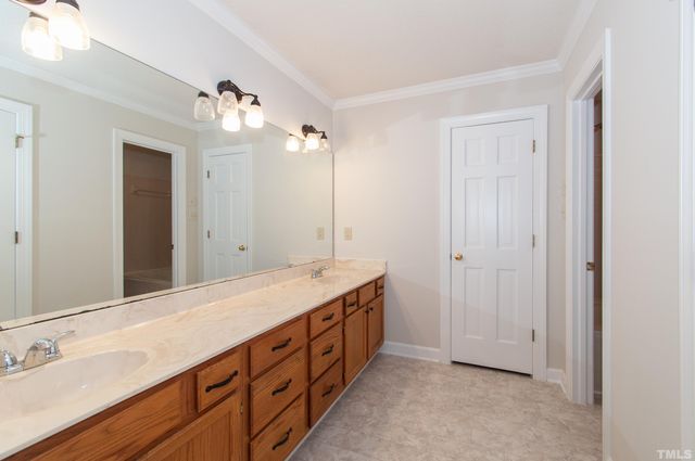 a spacious bathroom with a double vanity sink and a mirror