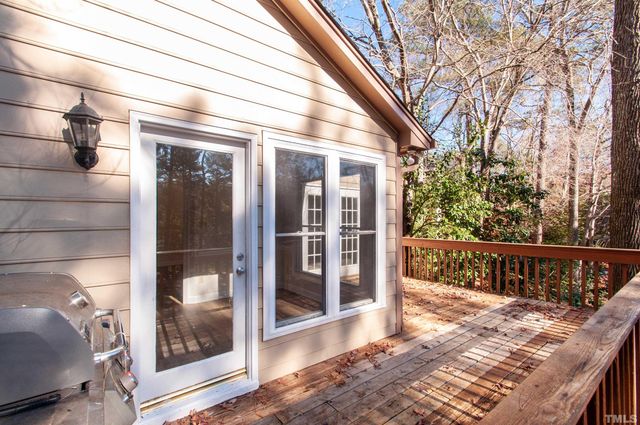 a view of balcony with floor to ceiling window and wooden fence