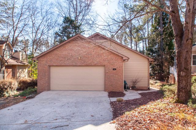 a front view of house with yard and trees