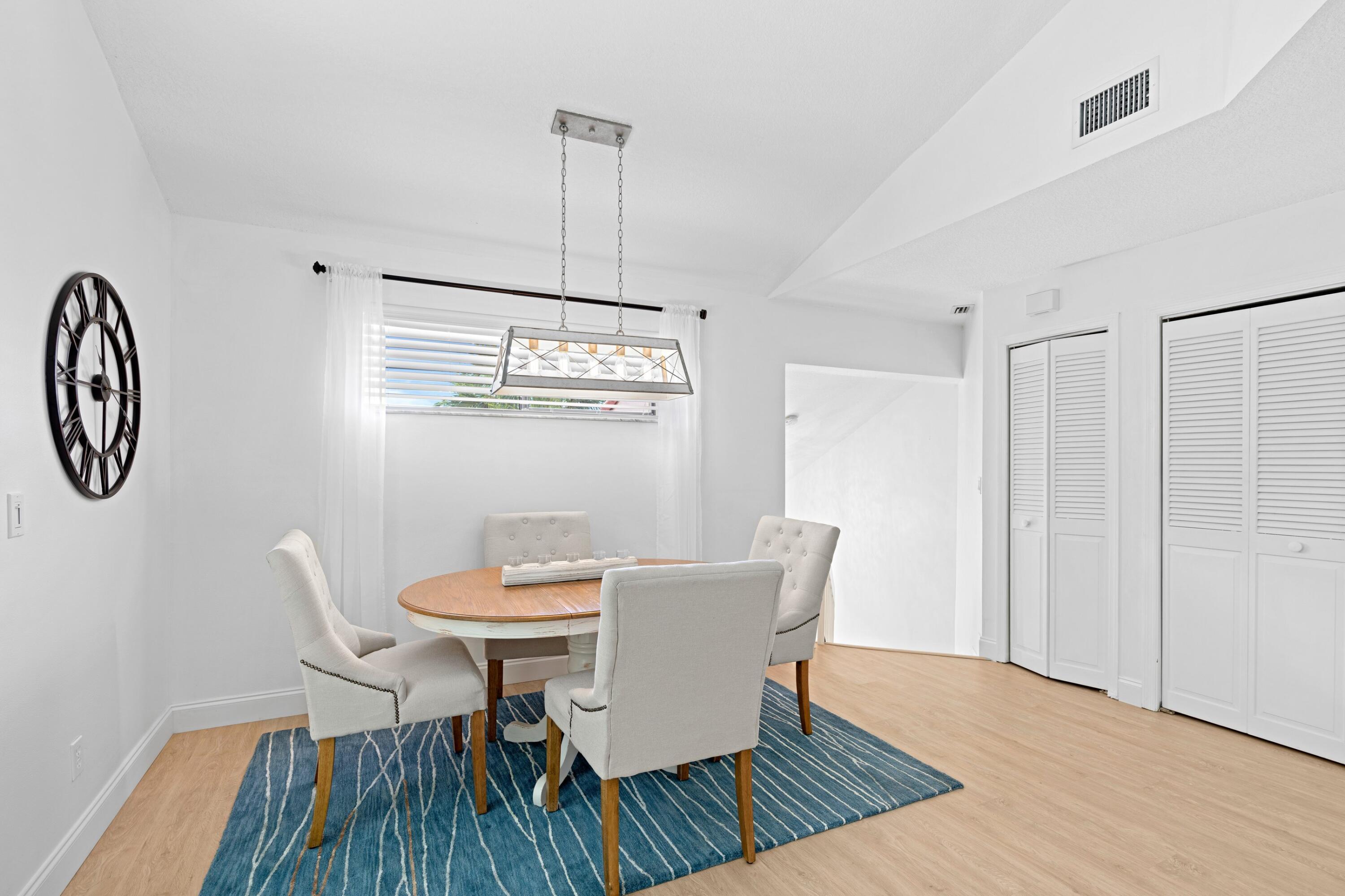 202 Sea Oats Drive Juno Beach, FL 33408 - Photo 11 of 17 a view of a dining room with furniture window and wooden floor