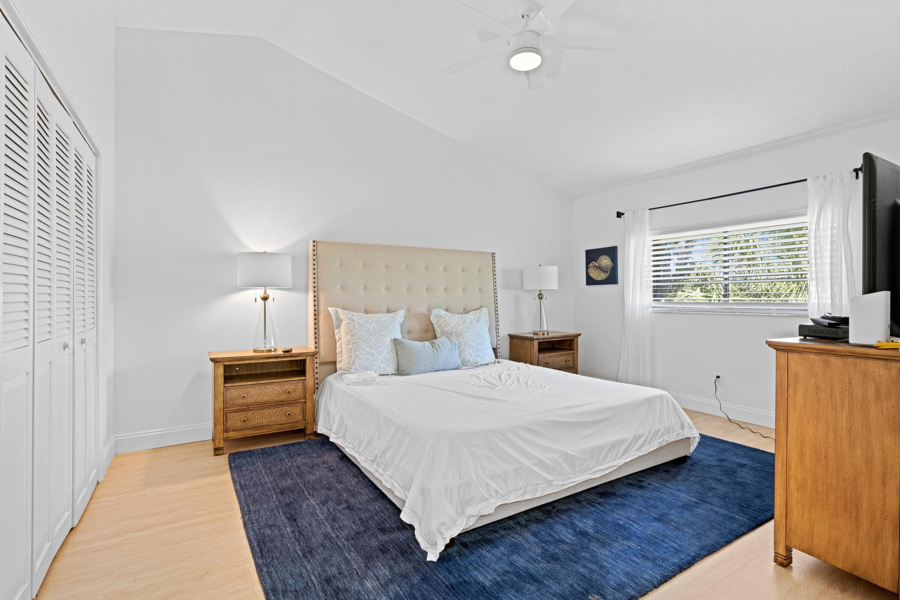 202 Sea Oats Drive Juno Beach, FL 33408 - Photo 13 of 17 a bedroom with a bed and wooden floor