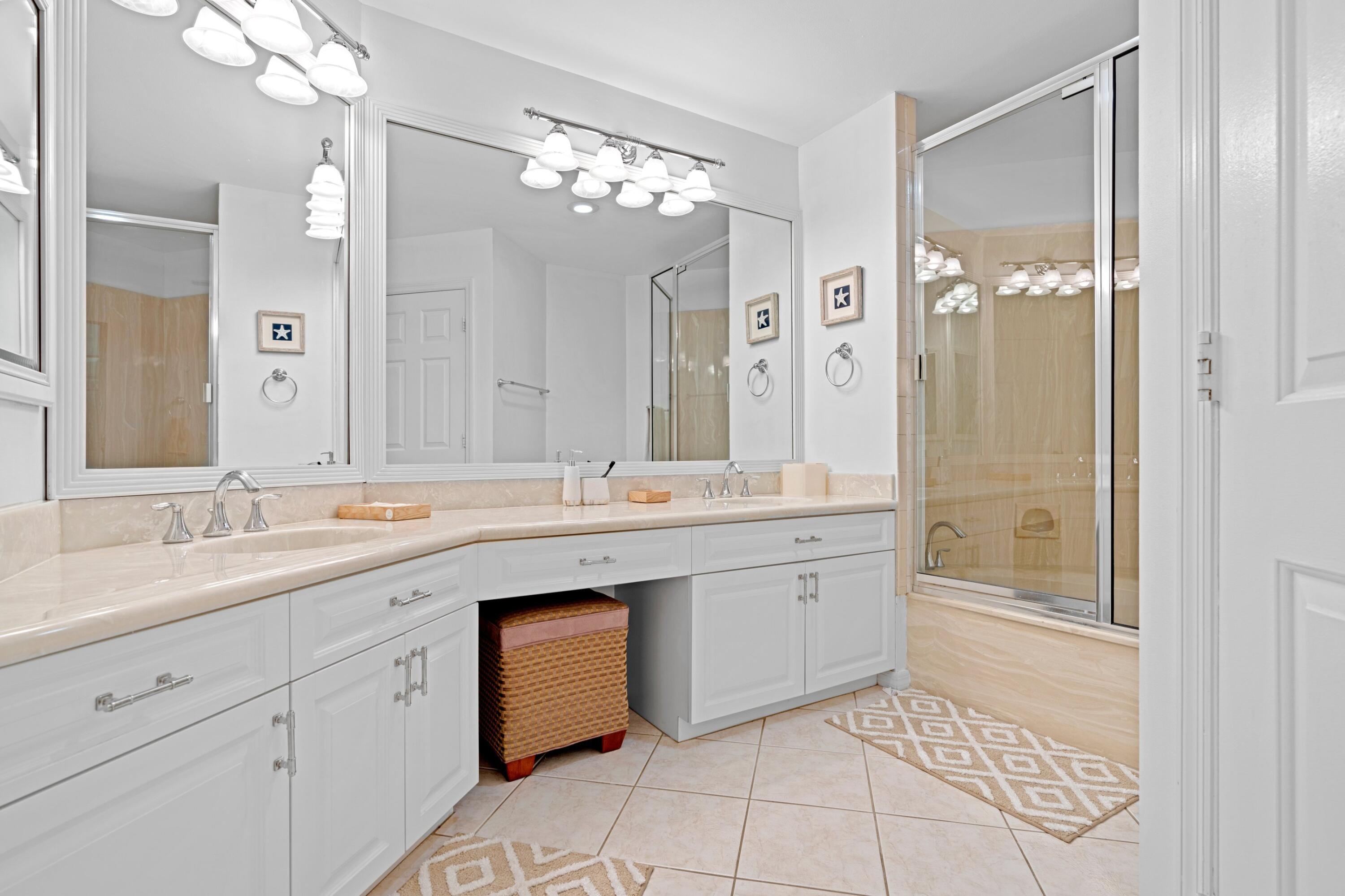 202 Sea Oats Drive Juno Beach, FL 33408 - Photo 14 of 17 a spacious bathroom with a granite countertop sink a toilet a mirror and shower