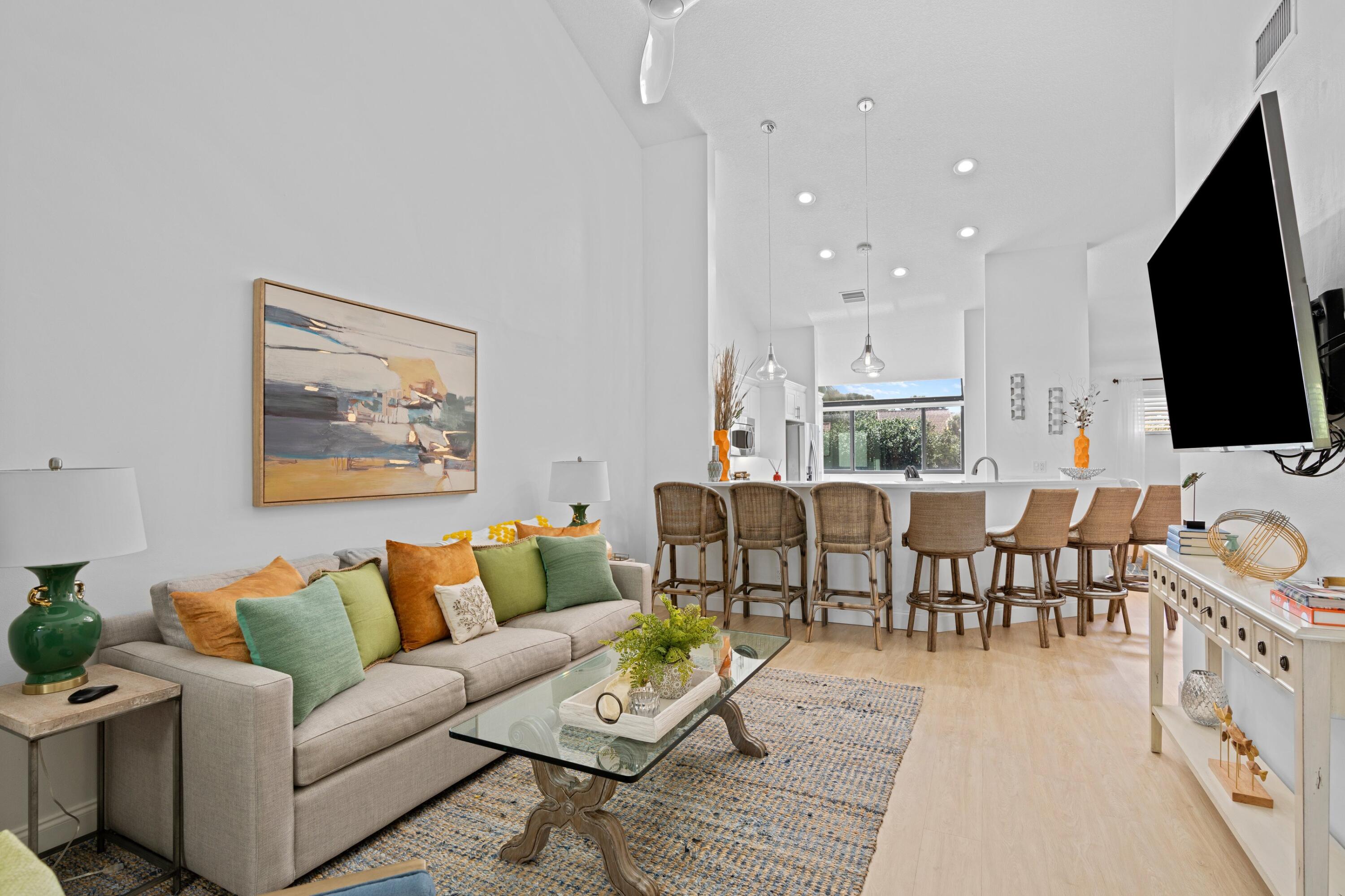 202 Sea Oats Drive Juno Beach, FL 33408 - Photo 4 of 17 a living room with furniture wooden floor and a flat screen tv