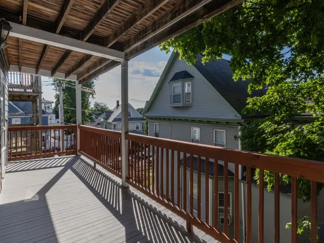 a view of a wooden deck with a yard