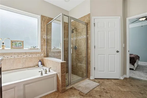 a bathroom with a tub a sink and a shower
