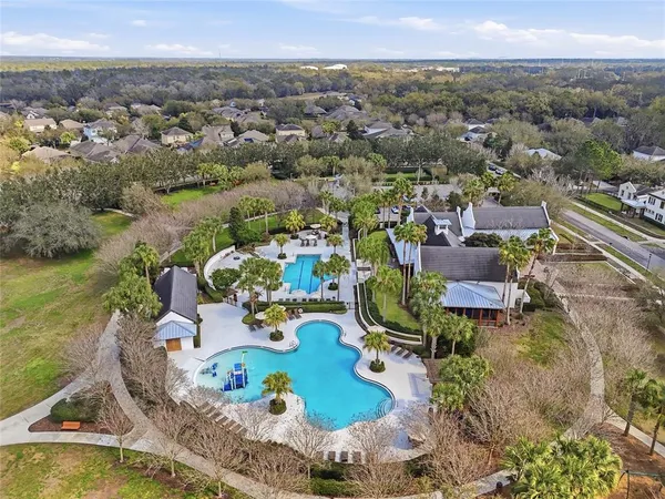 an aerial view of residential houses with outdoor space and swimming pool