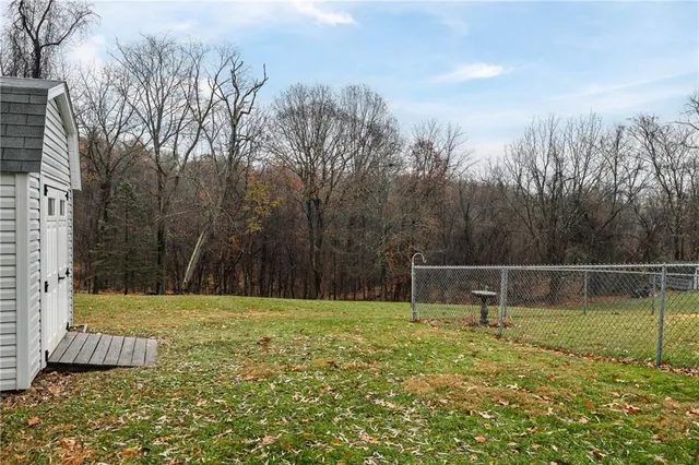 a view of a field with trees in the background