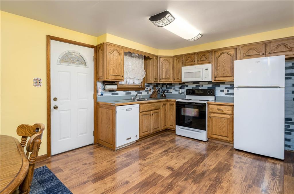 480 Alamae Lakes Road Washington, PA 15301 - Photo 10 of 20 a kitchen with stainless steel appliances granite countertop a stove top oven a refrigerator a sink and dishwasher with white cabinets