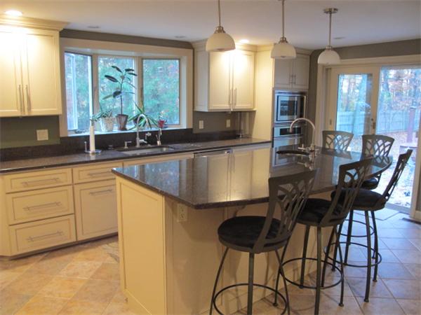 10 Anthony Road Wayland, MA 01778 - Photo 7 of 17 a kitchen with a table chairs microwave and cabinets