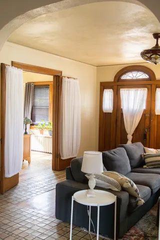 a living room with furniture and a wooden floor