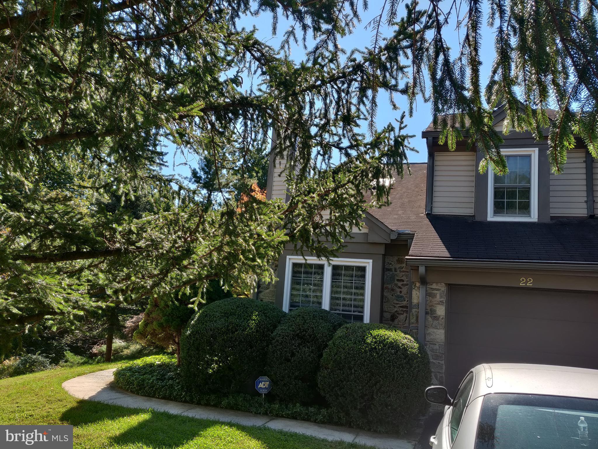 a view of a house with a large tree and a yard