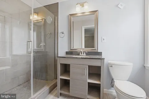 a bathroom with a toilet a sink and mirror