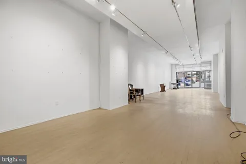 a view of a livingroom with a table and chairs