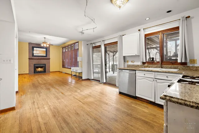 a kitchen with a sink appliances cabinets and a window