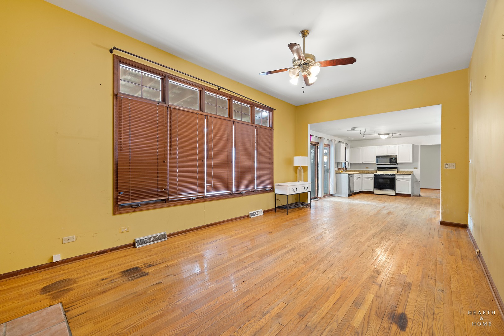 1207 Quail Run Avenue Bolingbrook, IL 60490 - Photo 32 of 48 a view of an empty room with a window and a kitchen