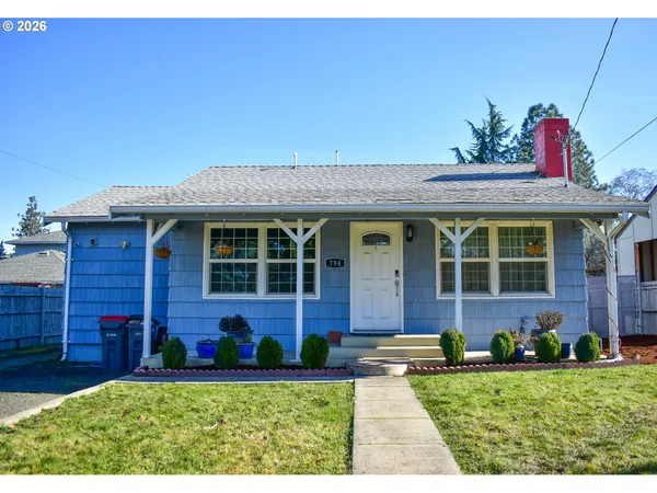 front view of a brick house with a yard